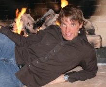 Sexy guy in front of fireplace